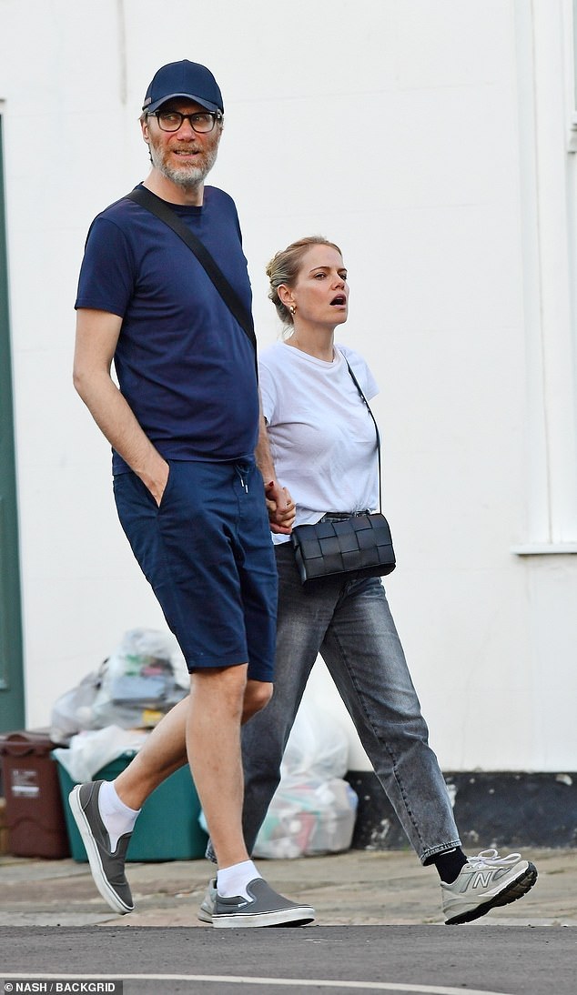 Holding hands: The couple showed off their noticeable height difference as the six-foot comedian towered over his six-foot girlfriend