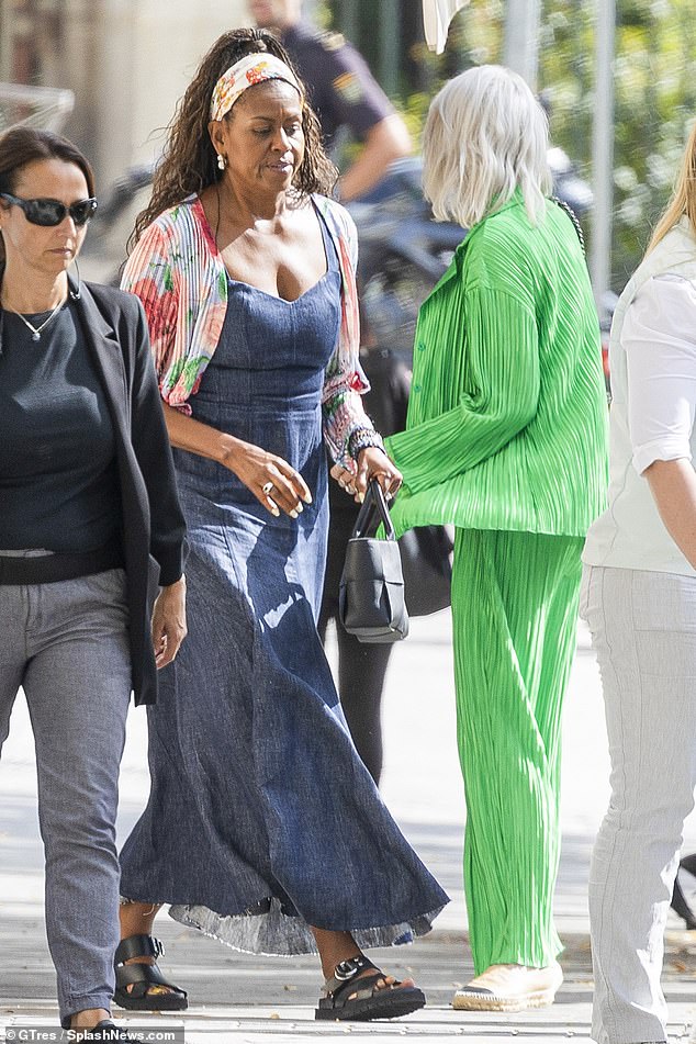 Michelle kept a straight face as she strolled the streets of Madrid in a pair of chunky black sandals