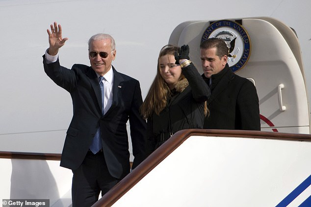 Then-Vice President Joe Biden waves as he leaves Air Force Two with his granddaughter Finnegan Biden and son Hunter Biden on December 4, 2013, in Beijing, China.