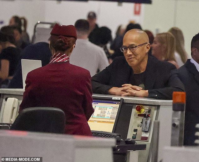 Dr.  Teo appeared cheerful as he chatted with an airline employee at the check-in desk before wheeling a small suitcase to his gate (pictured)