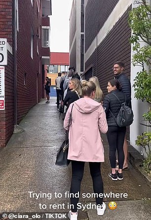 Many are seen waiting outside the unit on a cold and miserable day