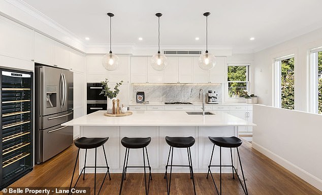 A generous extension to the rear has a spacious, open plan design and includes multiple living areas and a formal dining area.  Pictured: the kitchen