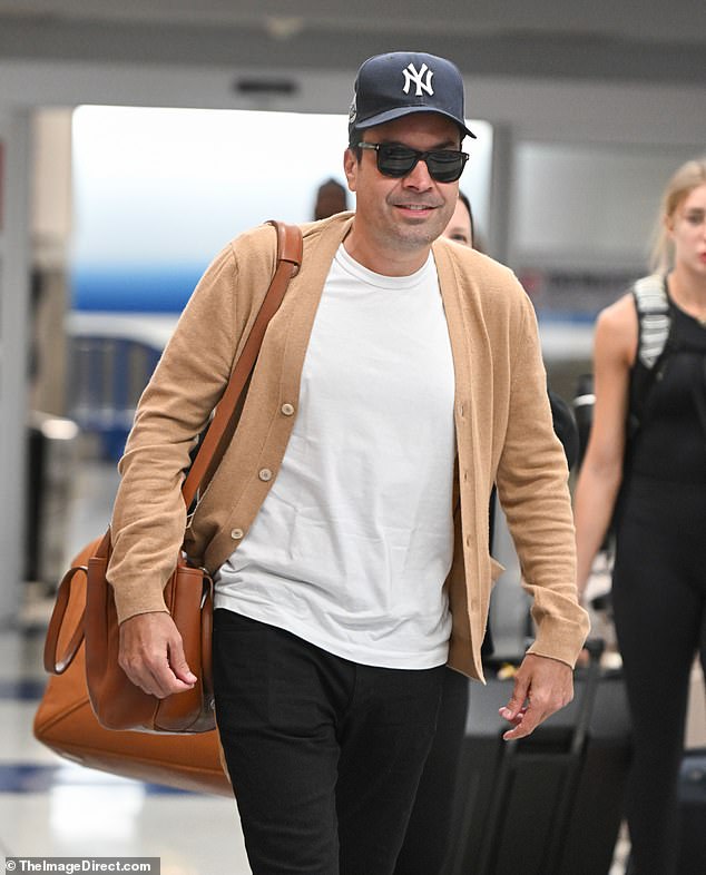 The 48-year-old sported a casual look in jeans and a white T-shirt with a beige cardigan over it