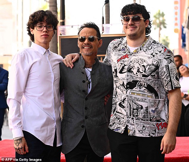 Proud Dad: The You Sang To Me crooner looked thrilled as two of his sons, Ryan Adrian Muñiz and Cristian Muñiz, joined him on the red carpet