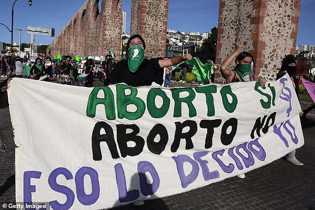 Protesters hold a banner that reads, “Abortion yes.  Abortion No. That's what I've decided' during a march on September 28, 2020 in Queretaro, Mexico