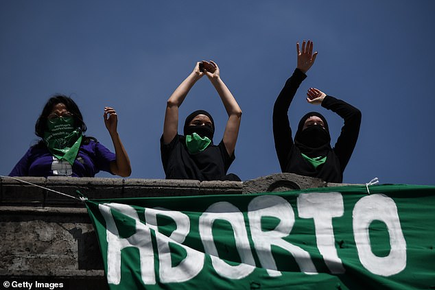 Members of the "Black block" put down a banner in favor of legal abortion during a demonstration for rights of choice on September 27, 2020 in Mexico City.  On Wednesday, Mexico's Supreme Court voted unanimously to lift the federal ban on the procedure