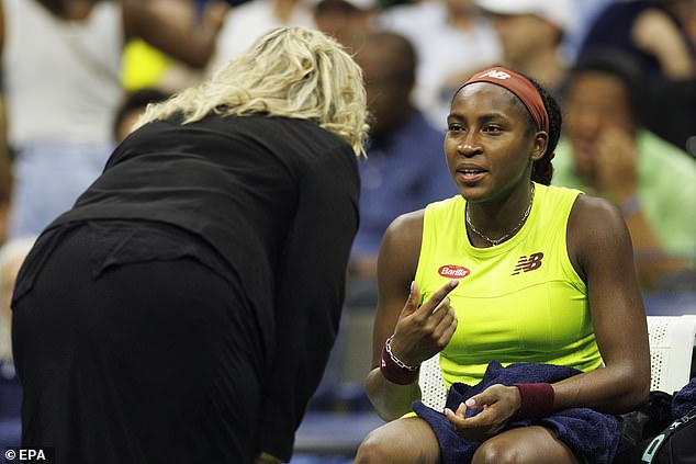 A match official speaks to Coco Gauff during the 45-minute protest delay on Thursday