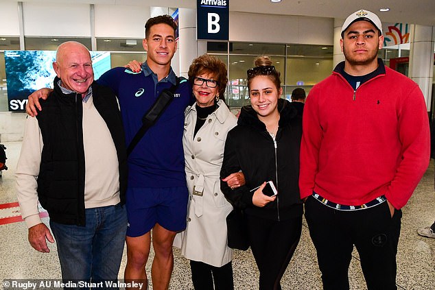 Mark Nawaqanitawase is greeted by family members at Sydney International Airport after finishing second in Argentina's Rugby World Cup U20s