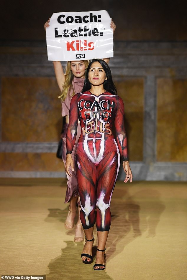 'Skinned': Two female PETA supporters brazenly stormed the catwalk – one of whom wore a grizzly body paint that gave the illusion of a 'skinned' body