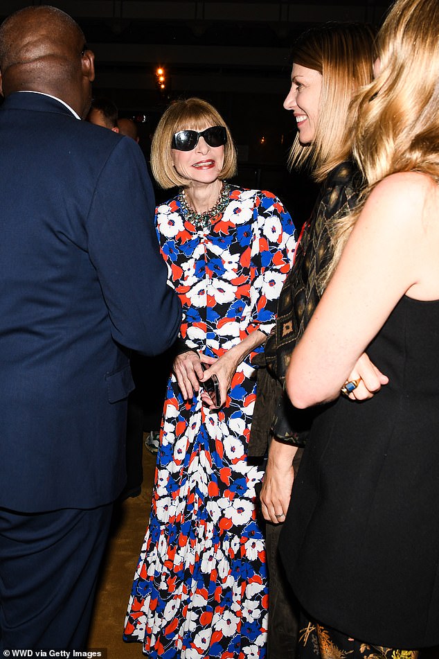 Queen: Anna Wintour looked radiant in a floral dress and her signature sunglasses