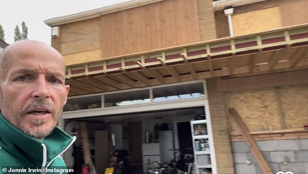 Renovation: Jonnie took a selfie video wearing a green tracksuit and stood in front of his family home as he showed how the bare bones of the porch were built