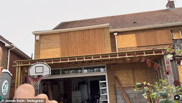 Exciting: Wood framing had been placed around the existing structure of the house and wood paneling had been added as the project looked good