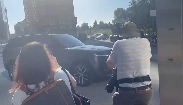 Photographers try to catch a glimpse of Prince Harry as his car arrives at the Hyatt Regency hotel in Dusseldorf