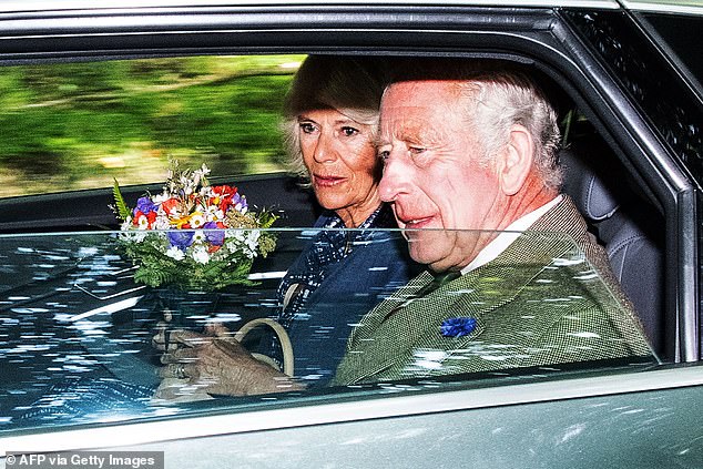 King Charles III appeared visibly moved after leaving a service to mark the first birthday of his mother, the Queen.  Camilla holds flowers presented to her by well-wishers