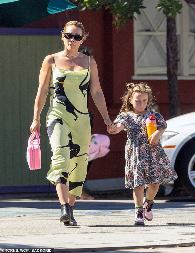 Loving mother: The Disney actress held her daughter's hand as they enjoyed some quality time together