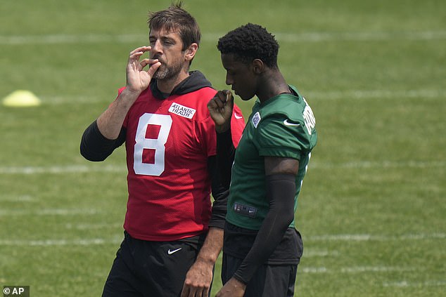 Rodgers, left, and Jets cornerback Sauce Gardner pretend to smoke during practice earlier in June