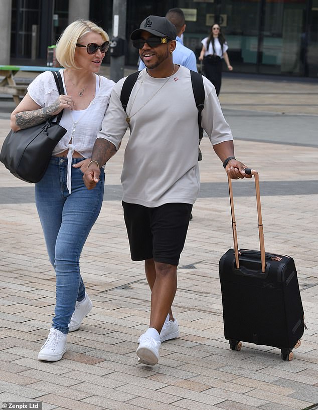 Mood: While Rachel flashed a beaming smile as she stepped out with her luggage, bandmates Jo O'Meara and Bradley McIntosh (pictured) shared a giggle as they walked side by side