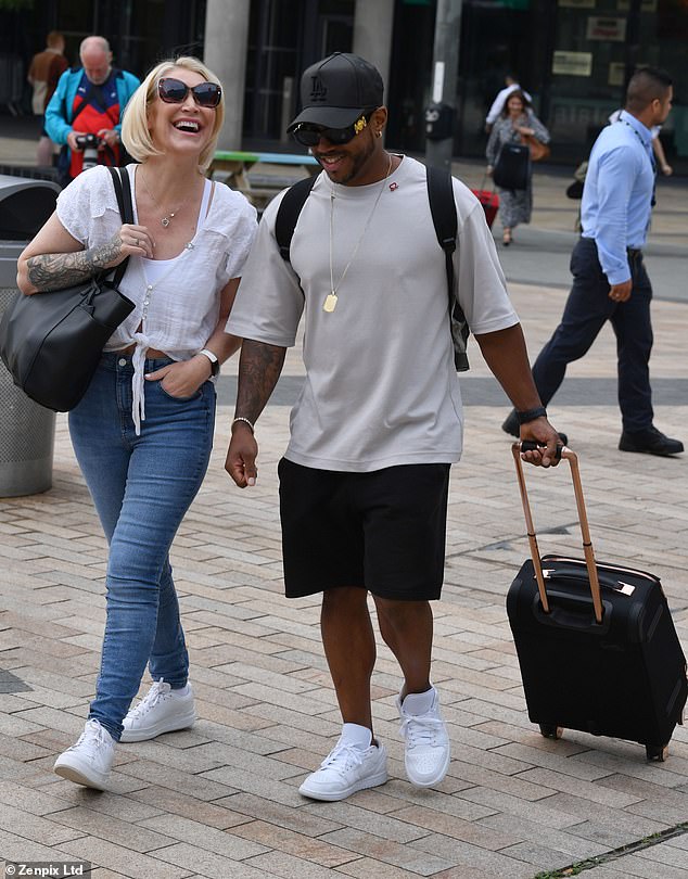 Good times: The duo were spotted walking together, with Bradley pulling a black suitcase behind him