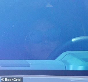 The mother of two pulled a pair of dark sunglasses over her face as she drove near her and Harry's $14 million home in Montecito
