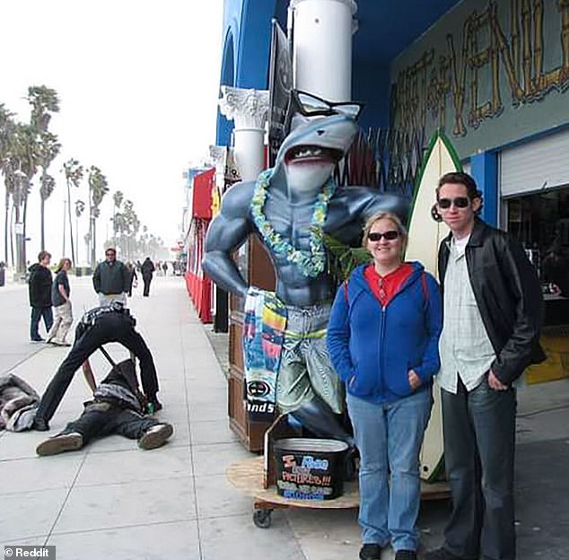 This husband and wife went on a trip to Los Angeles, California, but their vacation snap was photobombed by a police officer who knocked someone to the ground