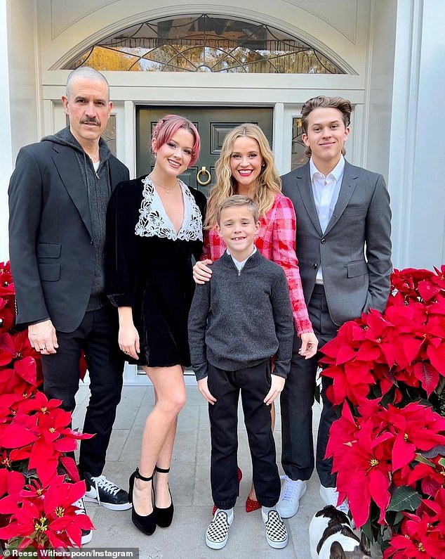 As they were: Her stepfather is Jim Toth, far left, from whom Reese is on the verge of divorce.  Together they have son Tennessee, center and front