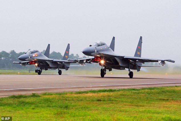 Two Chinese SU-30 fighter jets take off from an unknown location to fly a patrol over the South China Sea.