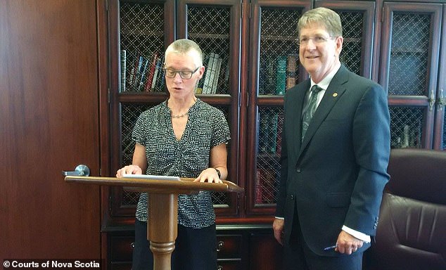 Judge Derrick (left) is seen during a swearing-in ceremony in 2017. 