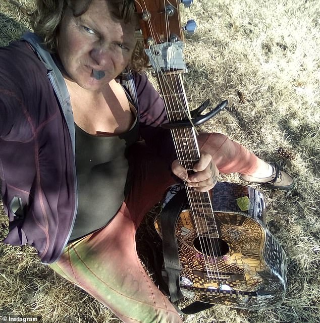 Shemansky, who appears to be a drifter, regularly shares bizarre music sessions on social media while playing the guitar, with one of her instruments (not pictured) adorned with a note that reads 'f*** your fascist beauty standards'.