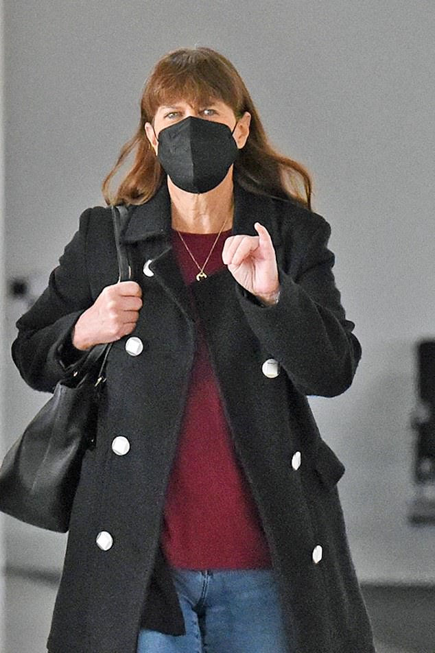 Terri looked cool but comfortable for the short-haul flight as she donned jeans, a maroon shirt and a long black coat