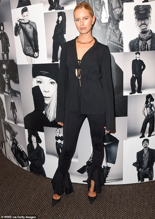 Chic: Karolina Kurkova also opted for an all-black look and wore fitted black trousers with a flared hem