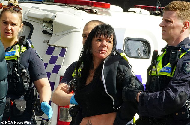 A man and woman (pictured) believed to be known to Preston arrived on the scene in the aftermath of the shooting and appeared to be arguing with police