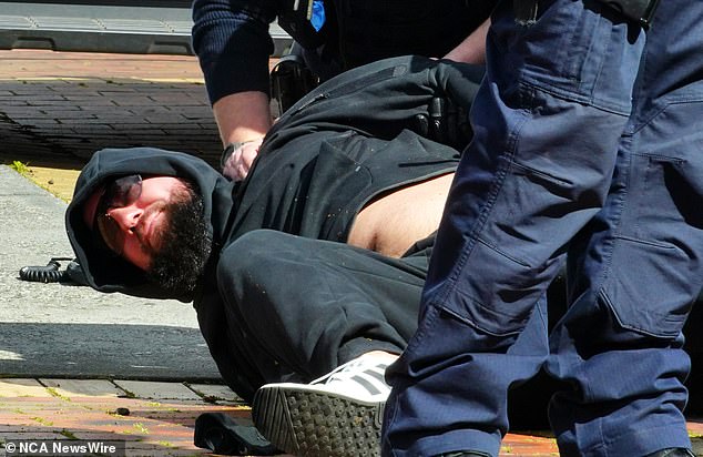 A man is stopped by police at the scene of Gavin Preston's shooting in Keilor Village