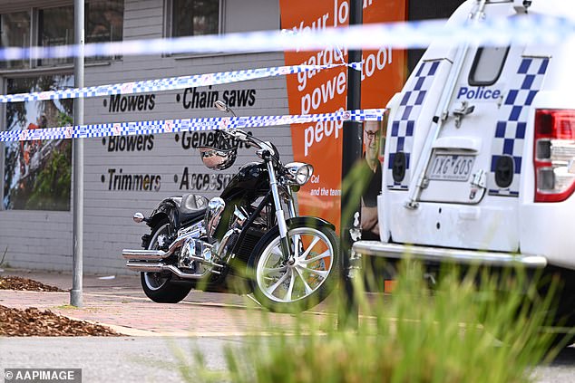 A motorcycle is seen as Victoria Police work the scene of Saturday morning's shooting at the Sweet Lulus Cafe in Keilor Village in Melbourne's northwest.