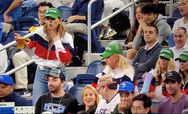 A female fan (left) tried to appease the angry Russian by blowing him a kiss from her seat