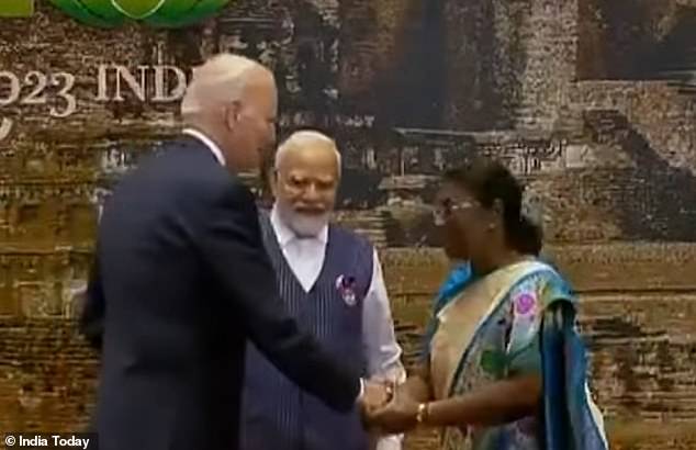 President Joe Biden (left) takes the hands of Indian President Droupadi Murmu (right) as Prime Minister Narendra Modi (center) looks on.  The president and other dinner guests are served a vegetarian meal with lots of Indian grain millet