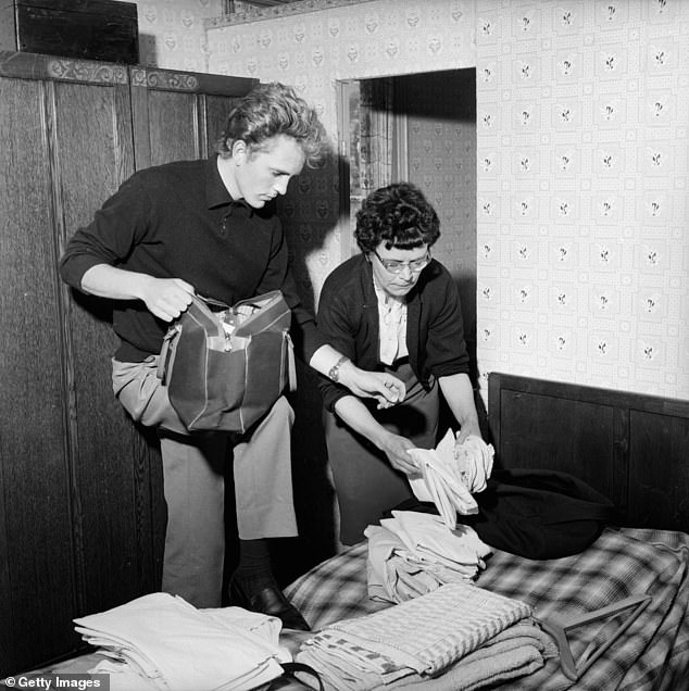 Leaving the house, 60s style: actor Terence Stamp with his mother Ethel.  She helps him pack for Spain