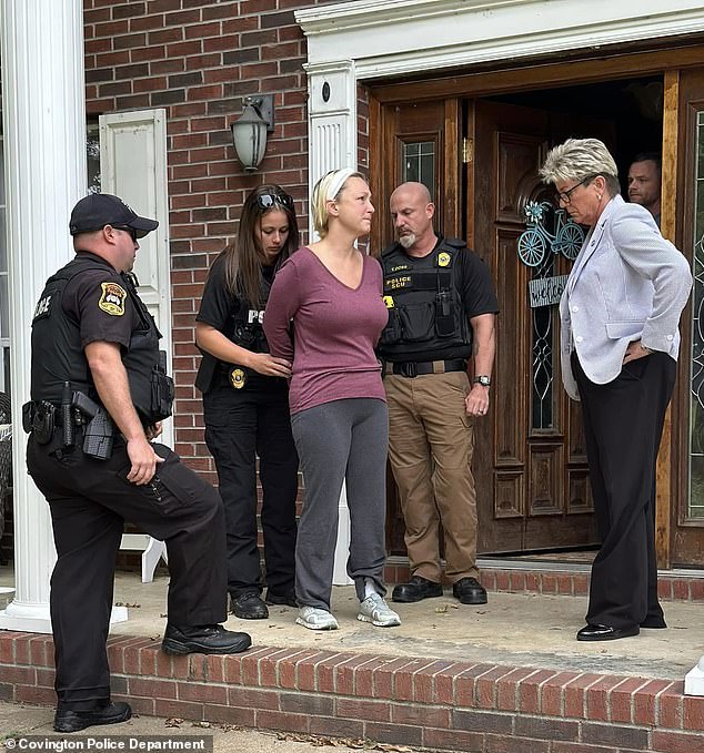 McCommon, wearing a maroon long-sleeved T-shirt, gray sweatpants and sneakers, was handcuffed by police outside her two-story brick home before being taken to the Tipton County Jail in a police vehicle.