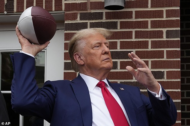 The former president signed footballs and threw them into the crowd of Iowa State football fans cheering him on