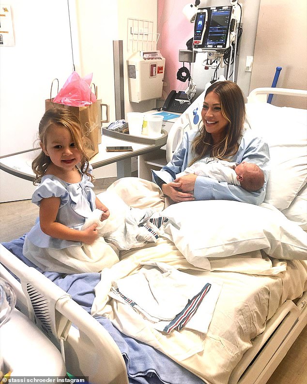 One photo shows Stassi and Beau's daughter Hartford Charlie Rose, two, meeting her new sibling for the first time