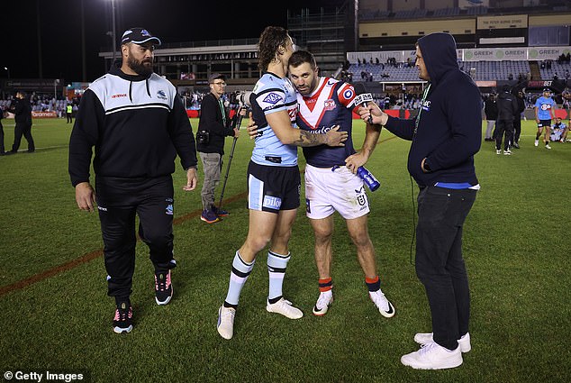 Nicho Hynes congratulates Roosters superstar James Tedesco after the Chooks recorded a stunning one-point win to end Cronulla's season