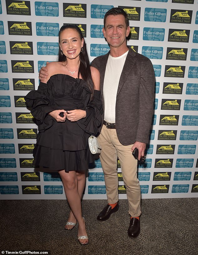 Friends: Millie paired the dress with a pair of silver glitter heels and a small matching handbag, while Scott looked dapper alongside a pair of bright orange socks