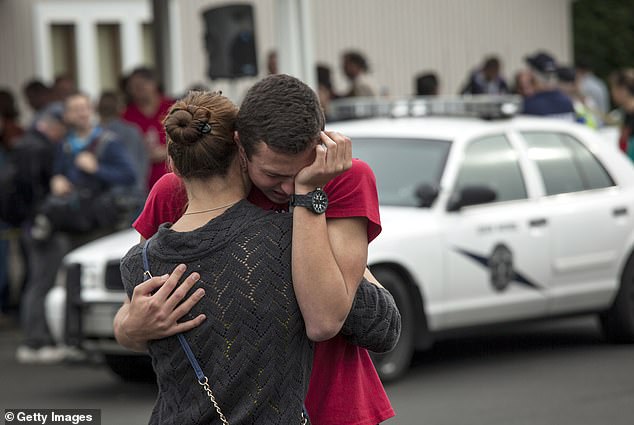 A student hugs a family member from Shoultes Christian Assembly after being evacuated from Marysville-Pilchuck High School in the aftermath of a shooting on the high school campus in Marysville, Washington