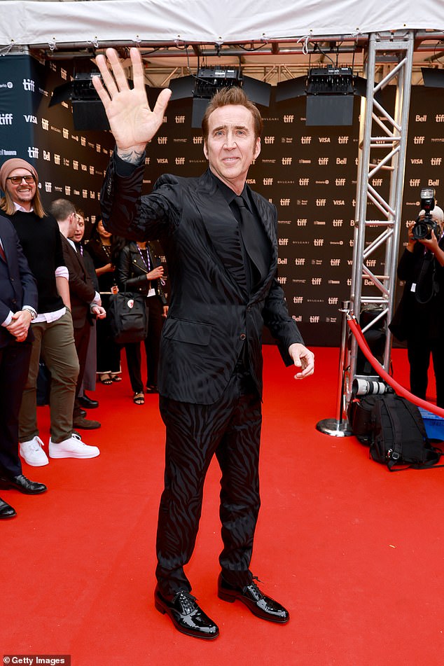 Fashion forward: Oscar-winning actor steppe dout in an all-black animal print suit that he paired with a matching shirt, tie and shoes