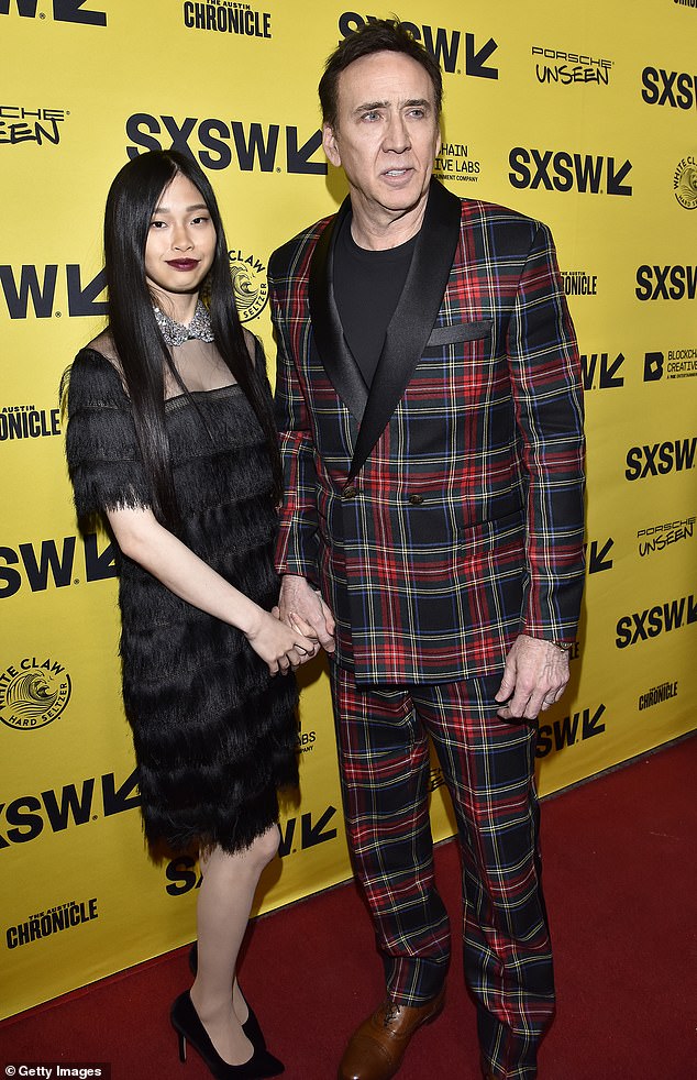 Proud parents: Cage shares his daughter with fifth wife Riko Shibata, whom he married in February 2021;  they are pictured in Austin, Texas, March 2022