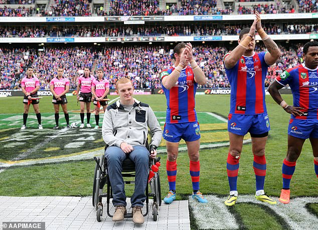 McKinnon is pictured with his Newcastle teammates as he is honored at the Knights' home ground just months after the life-changing injury