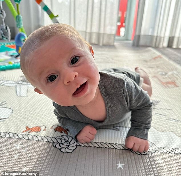 One photo shows the boy looking cheekily at the camera from his playpen