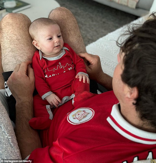 She also shared an adorable photo of her son resting in his father's lap as Garry looked down on him lovingly.