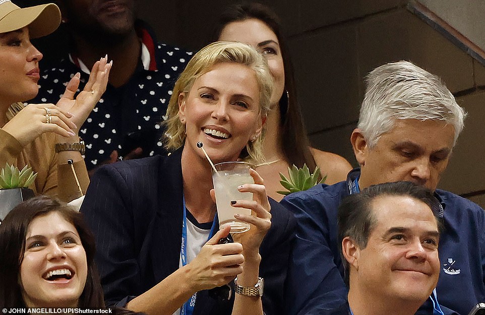 Charlize smiled brightly from her seat, which was not far from Alexandra's