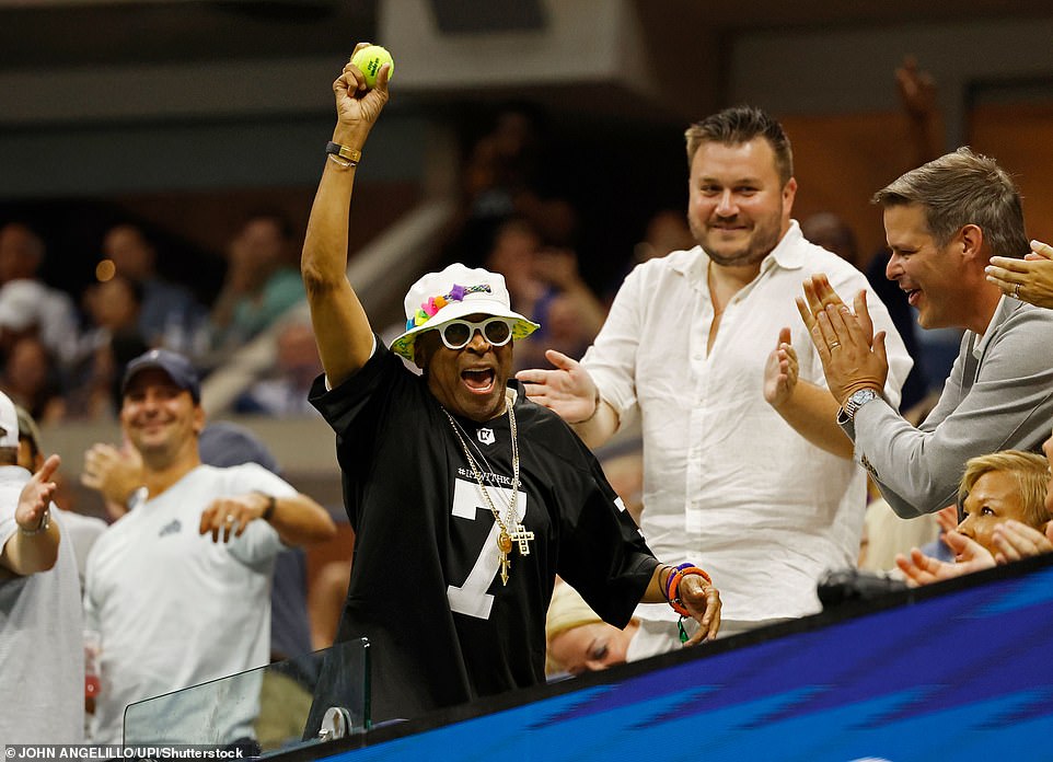 Wearing a white bucket hat, director Spike Lee let out a celebratory shout and held up a tennis ball