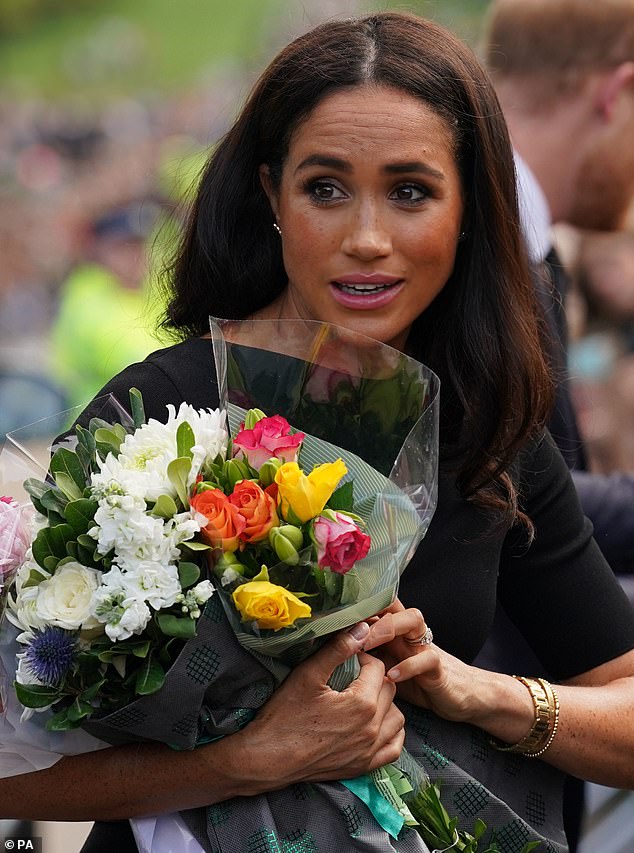 After some back and forth, Meghan, 41, eventually did so, politely thanking the aides accompanying the royal couple for their help.